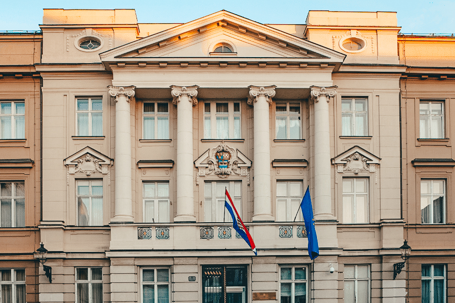 Zagreb parliament building with the Croatian flags flying out the front