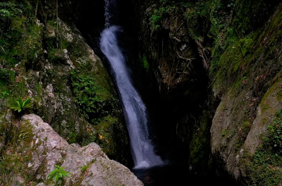 The waterfalls at Fairy Falls cascading through the rock faces
